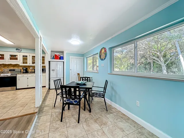 a view of a dining room with furniture and a window