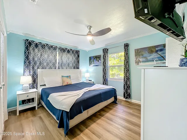 a bedroom with a bed lamp and a window