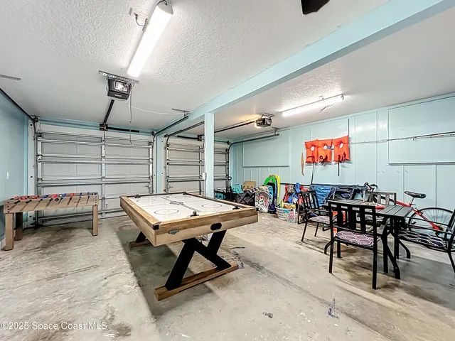 a room with gym equipment and a chandelier