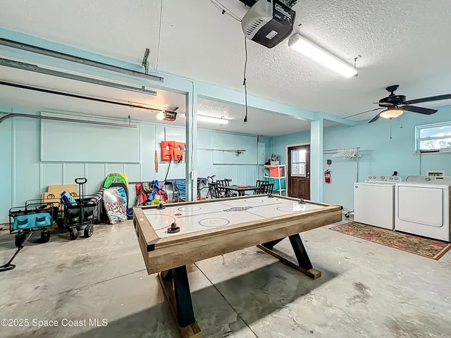 a patio with wooden floor a yard tables and chairs