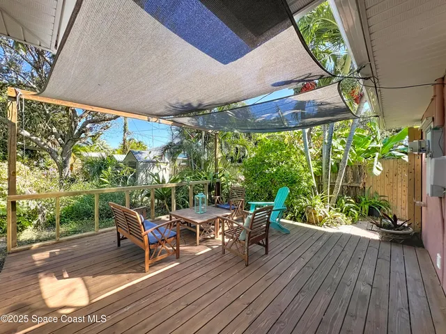 a view of a patio with table and chairs potted plants with wooden floor