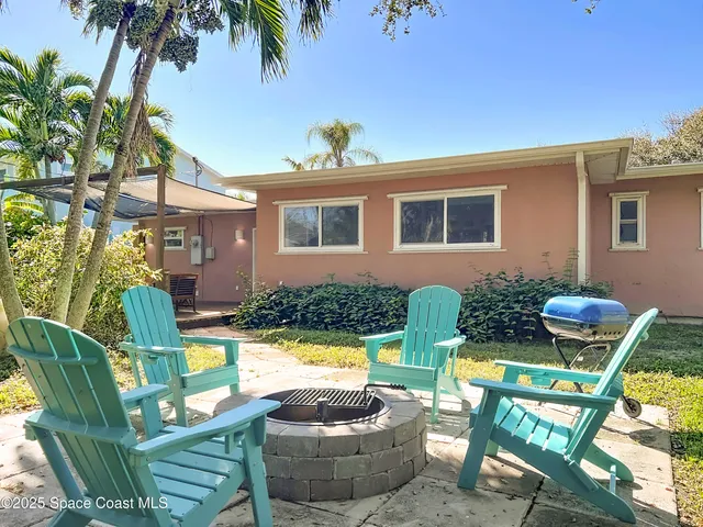 a view of a chair and table in backyard