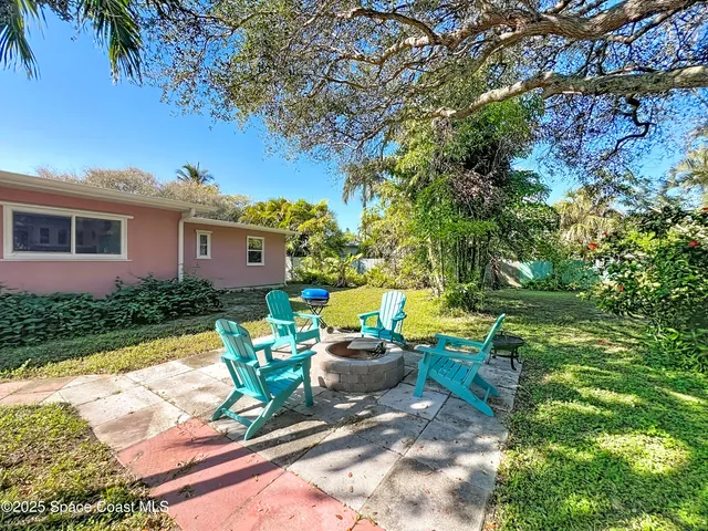 a view of a house with swimming pool and sitting area