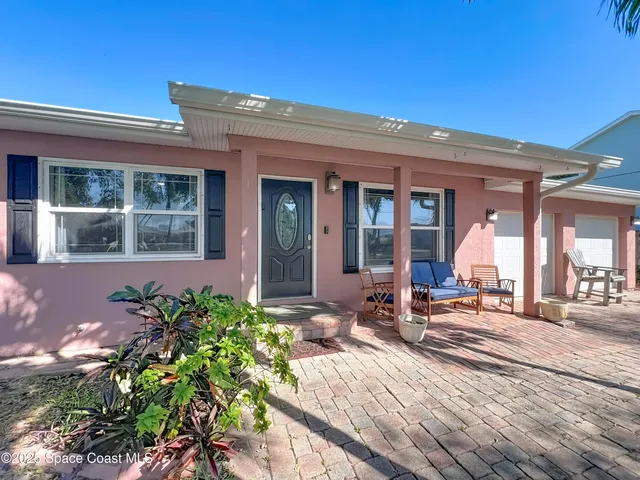 a view of a house with backyard sitting area and porch