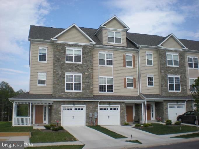 74 Backstretch Way Prince Frederick, MD 20678 - Photo 1 of 21 a front view of a house with garden