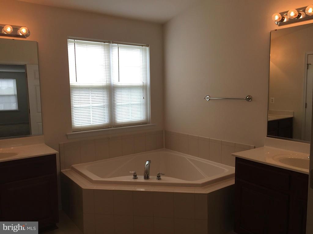 74 Backstretch Way Prince Frederick, MD 20678 - Photo 16 of 21 a bathroom with a bathtub and a window