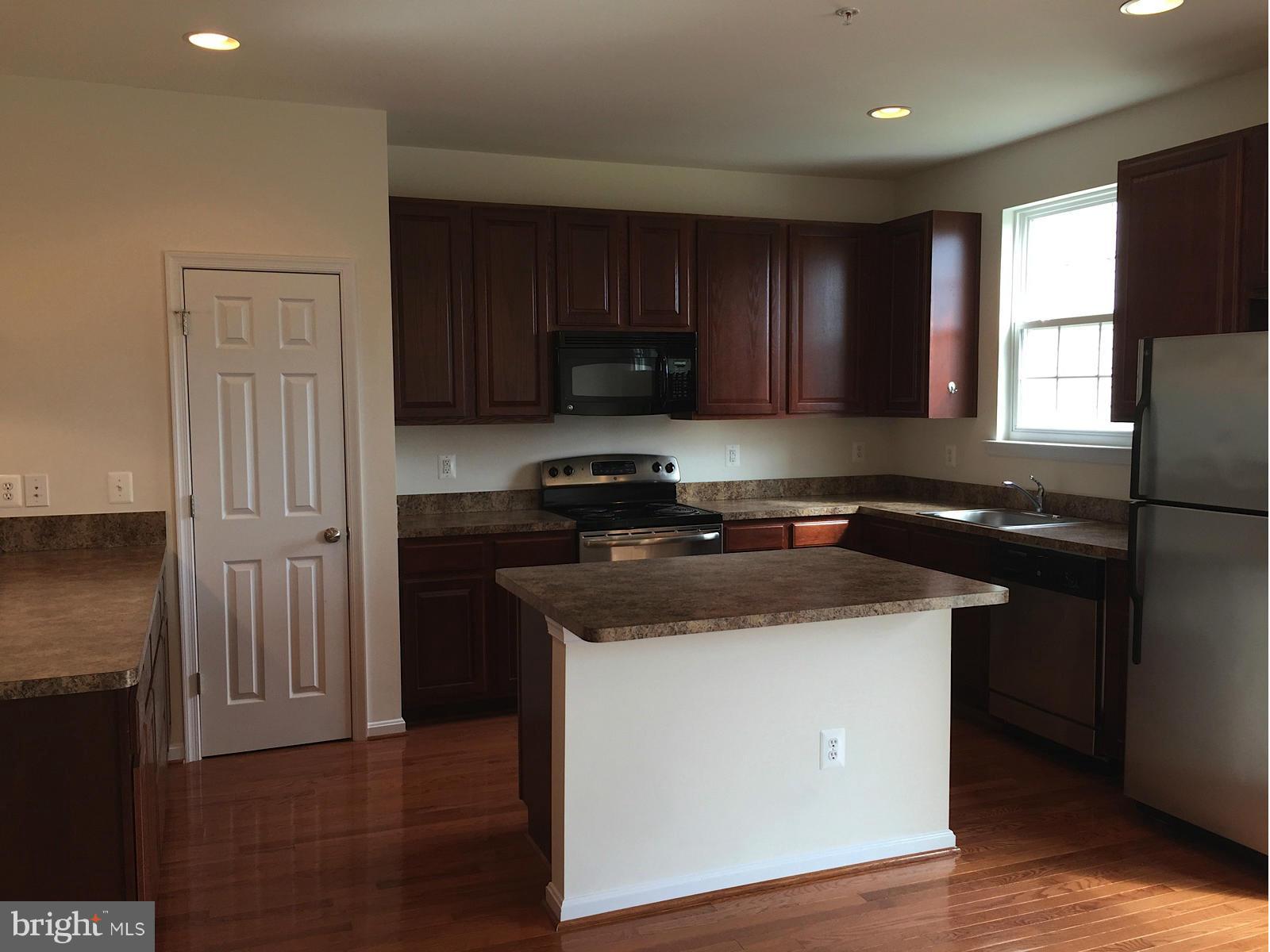 74 Backstretch Way Prince Frederick, MD 20678 - Photo 3 of 21 a kitchen with a sink stove top oven and cabinets