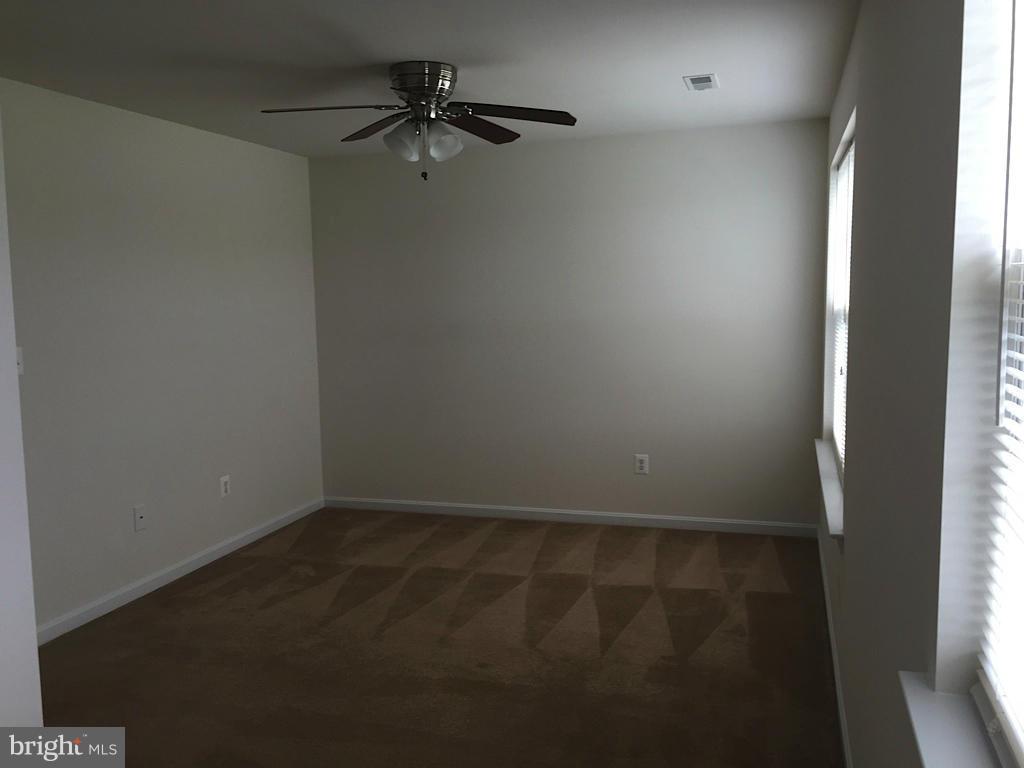 74 Backstretch Way Prince Frederick, MD 20678 - Photo 9 of 21 en empty room with a window