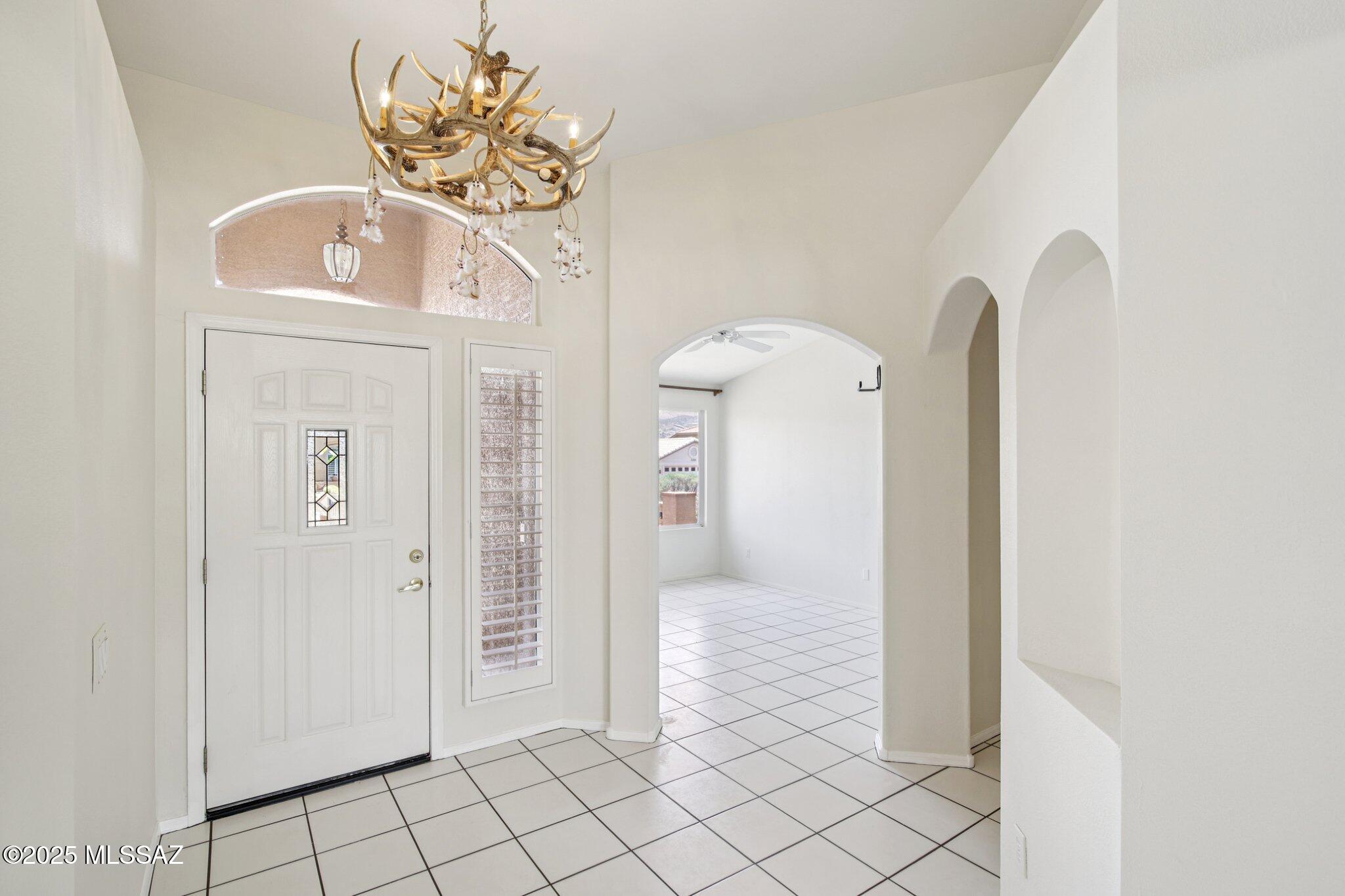 35890 Mesa Ridge Drive Tucson, AZ 85739 - Photo 4 of 31 a view of a hallway to front door with wooden floor