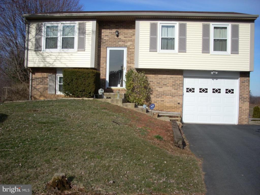 152 April Lane, Unit 17543 Lititz, PA 17543 - Photo 1 of 9 a front view of a house with a yard