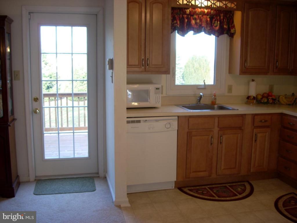 152 April Lane, Unit 17543 Lititz, PA 17543 - Photo 6 of 9 a kitchen with a sink window and cabinets