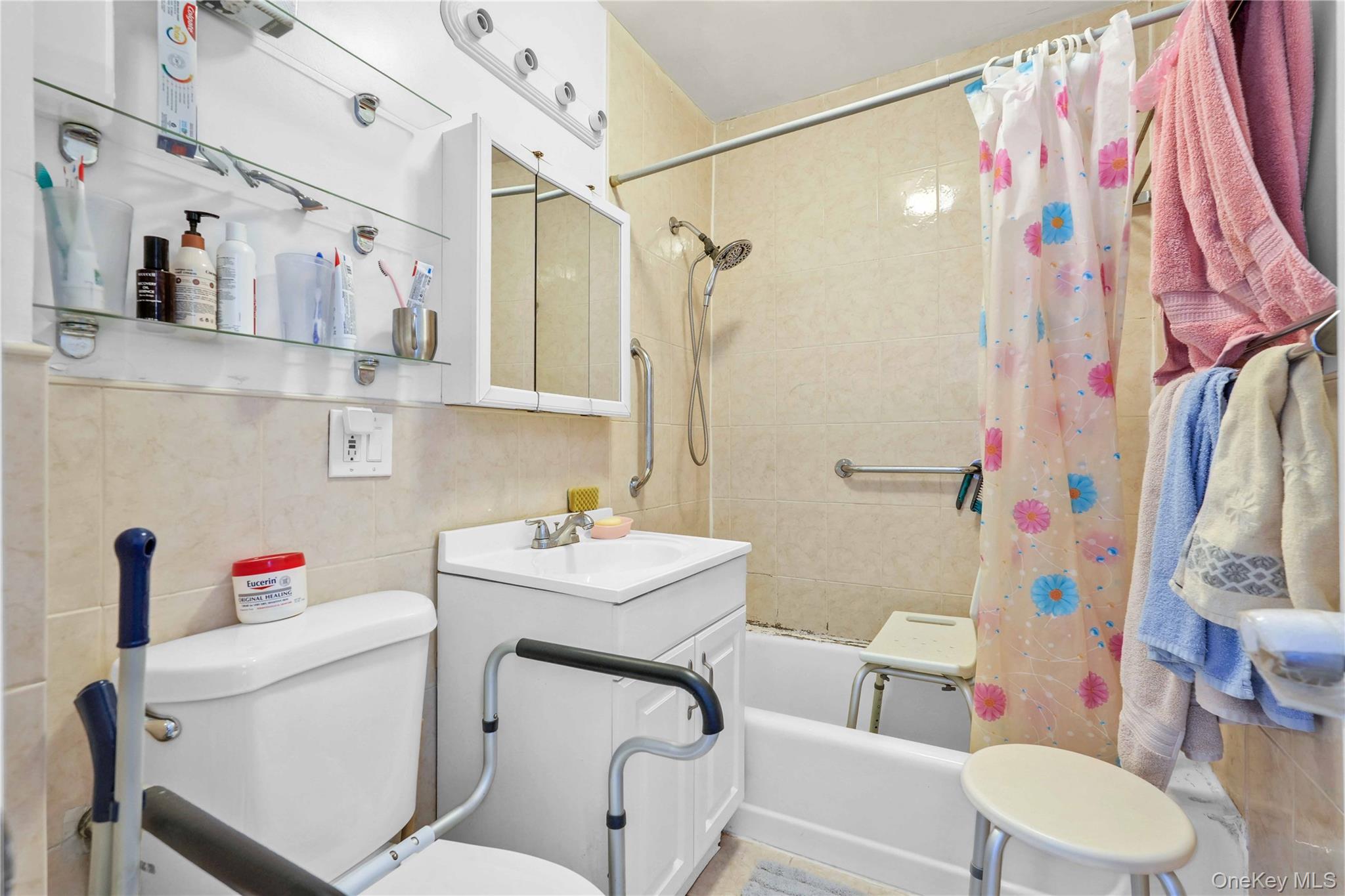 58-03 Calloway Street, Unit 5A Queens, NY 11368 - Photo 15 of 19 a bathroom with a sink toilet vanity and shower
