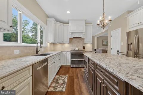 a kitchen with a stove sink and cabinets