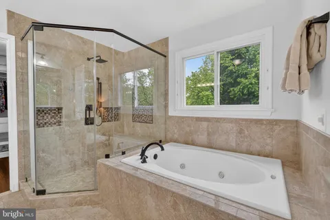 a bathroom with a bathtub and a shower