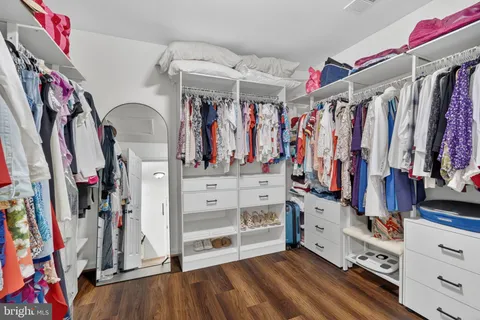 a view of walk in closet with clothes