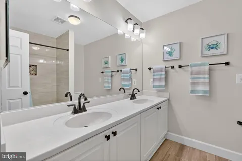 a bathroom with a sink double vanity and a mirror