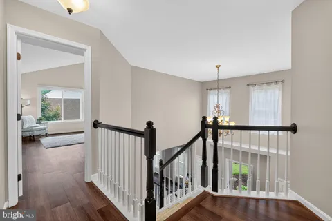 a view of a hallway with wooden floor and entryway