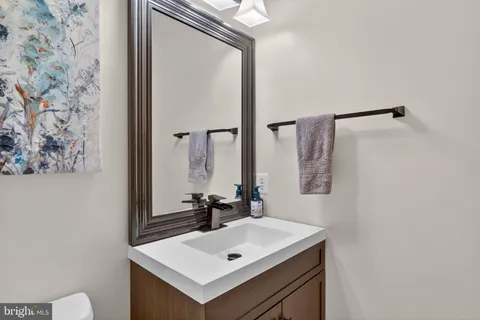 a bathroom with a sink vanity and a mirror