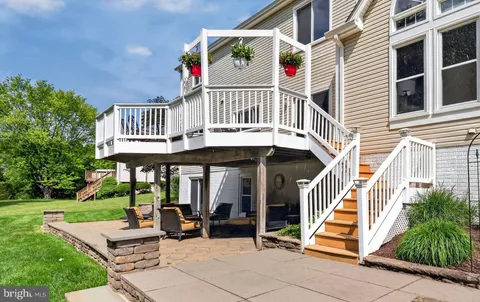 a front view of a house with porch and garden