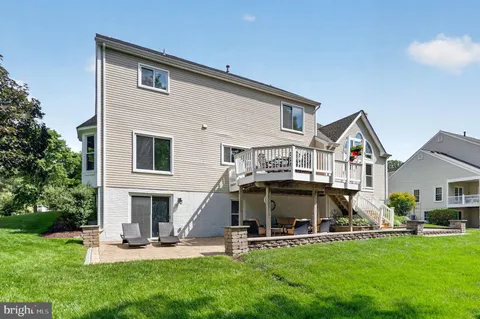 a view of a house with a yard and sitting area