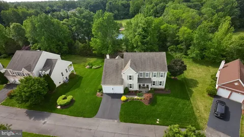 an aerial view of a house with garden space and street view