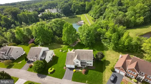an aerial view of a house with garden space and street view
