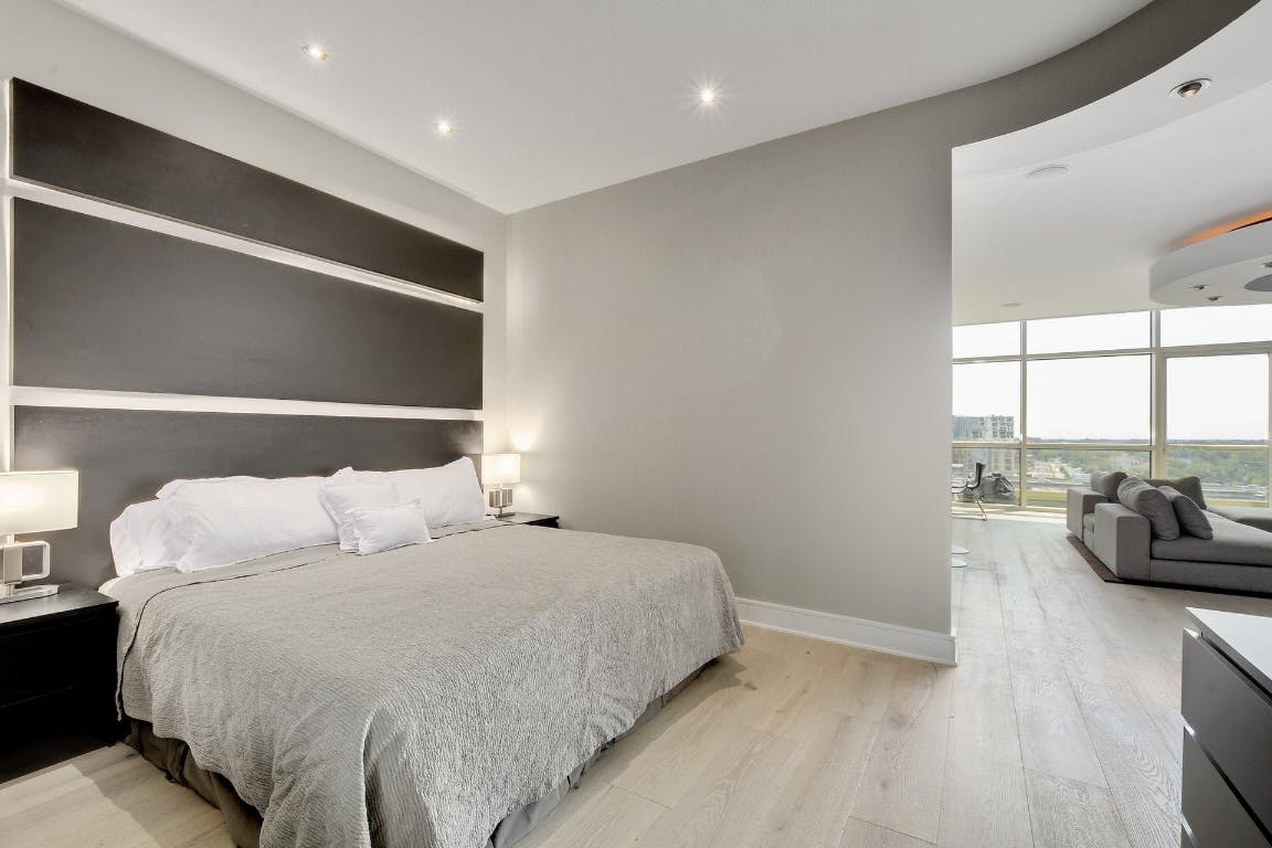 555 East 5th Street, Unit 723 Austin, TX 78701 - Photo 11 of 18 a bedroom with a bed and large windows