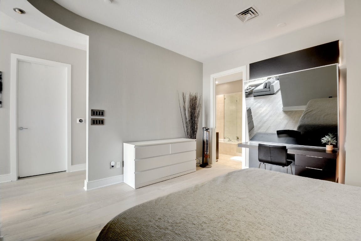 555 East 5th Street, Unit 723 Austin, TX 78701 - Photo 12 of 18 a bedroom with a bed and furniture