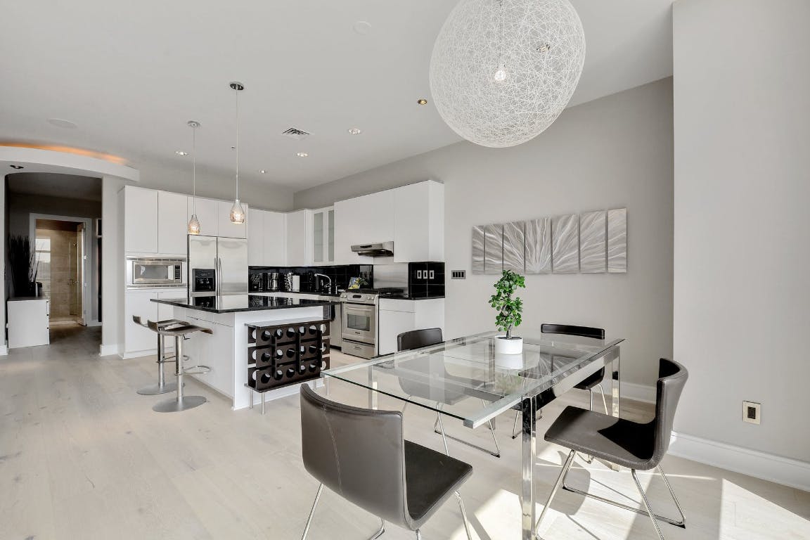 555 East 5th Street, Unit 723 Austin, TX 78701 - Photo 8 of 18 a kitchen with stainless steel appliances kitchen island granite countertop a sink and cabinets