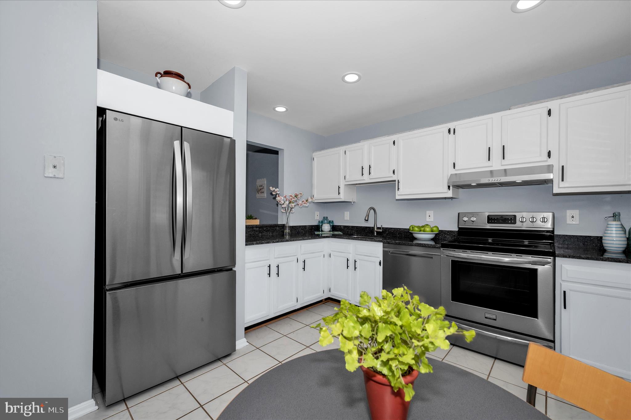 10120 Nightingale Street Gaithersburg, MD 20882 - Photo 1 of 56 a kitchen with stainless steel appliances a refrigerator sink and a white cabinets