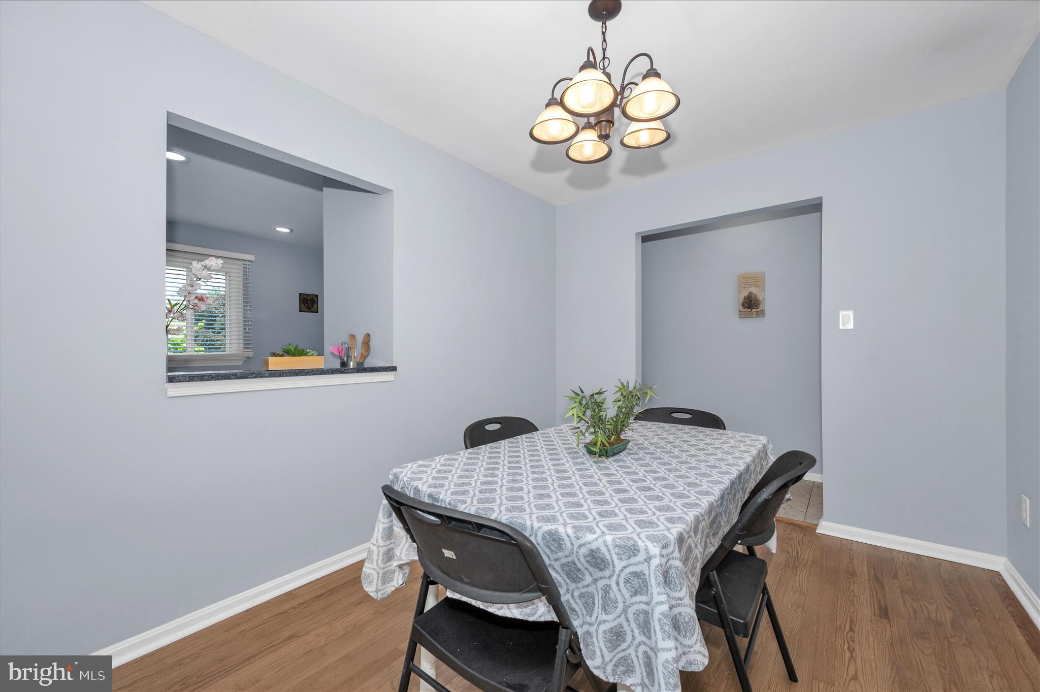 10120 Nightingale Street Gaithersburg, MD 20882 - Photo 12 of 56 a view of a dining room with furniture and wooden floor