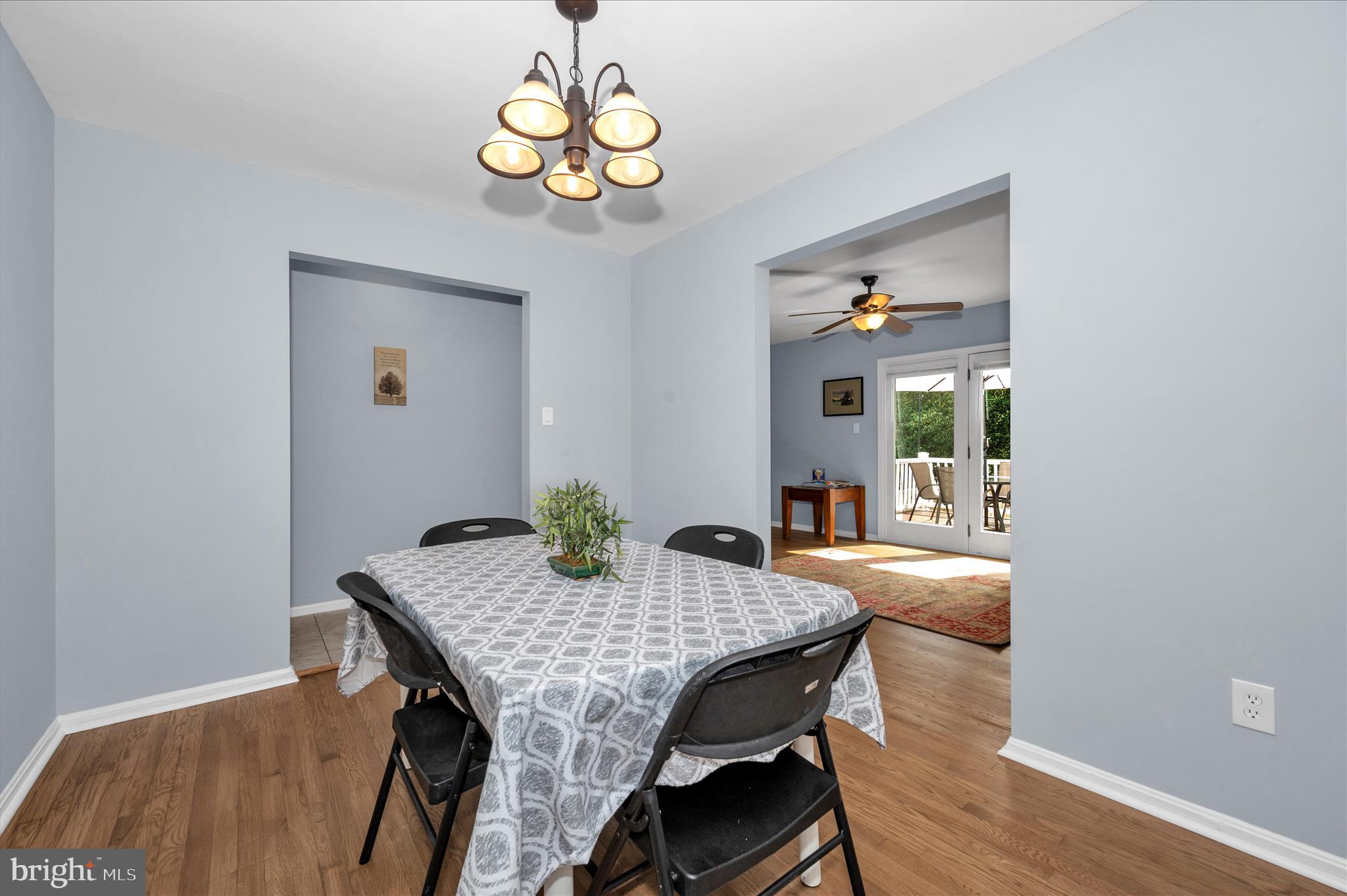 10120 Nightingale Street Gaithersburg, MD 20882 - Photo 13 of 56 a view of a dining room with furniture wooden floor and chandelier