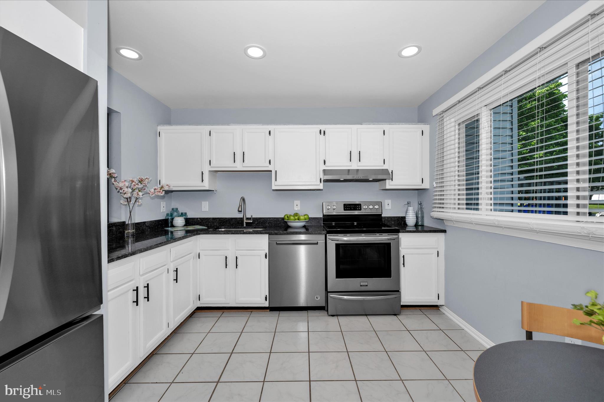 10120 Nightingale Street Gaithersburg, MD 20882 - Photo 16 of 56 a kitchen with a sink a stove and cabinets