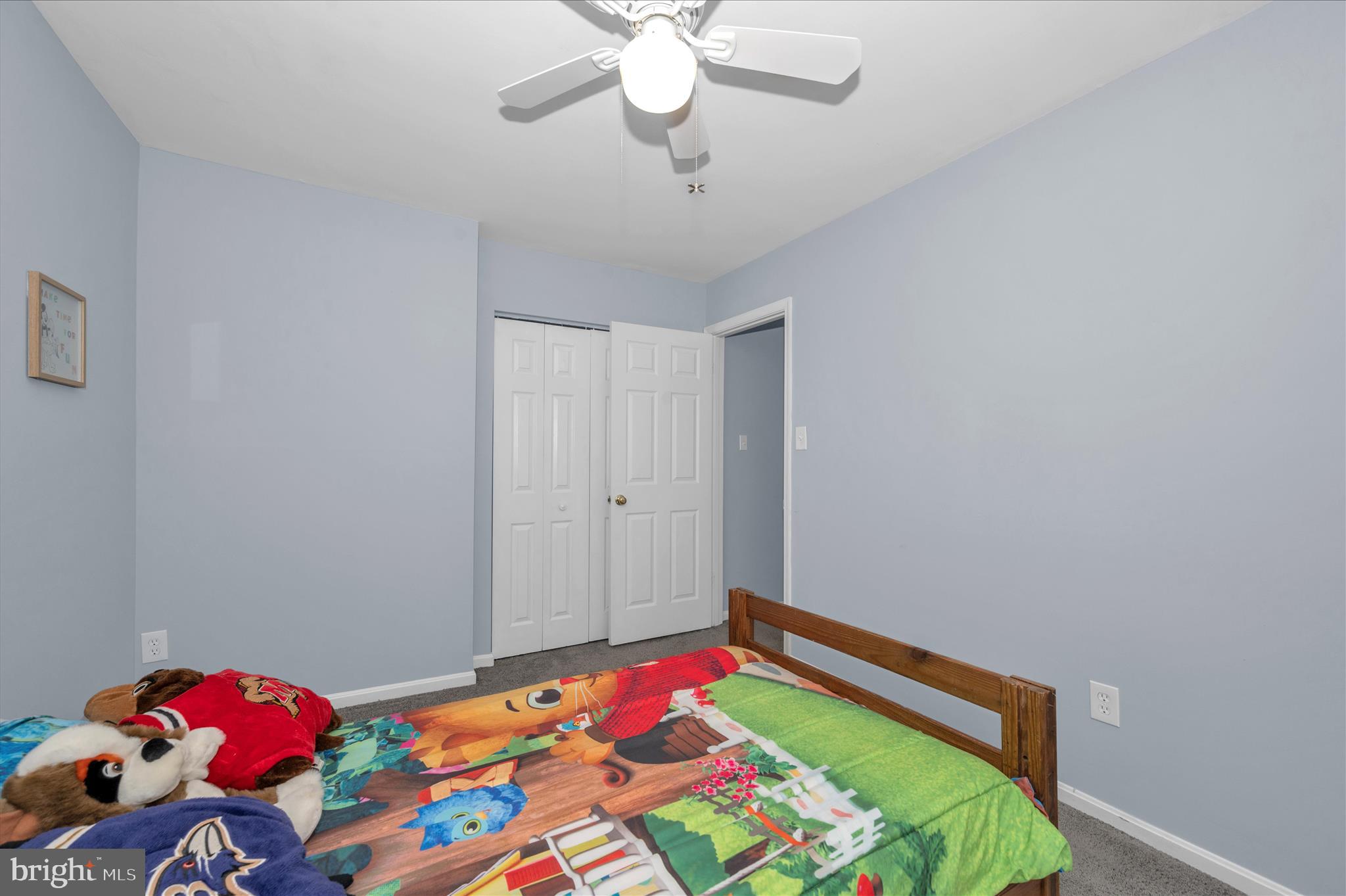 10120 Nightingale Street Gaithersburg, MD 20882 - Photo 29 of 56 a bedroom with a bed and a chandelier fan