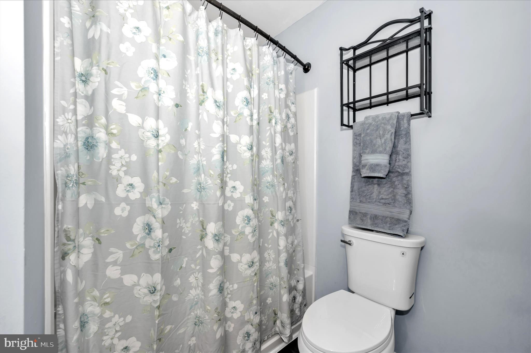10120 Nightingale Street Gaithersburg, MD 20882 - Photo 34 of 56 a white toilet sitting next to a shower curtain