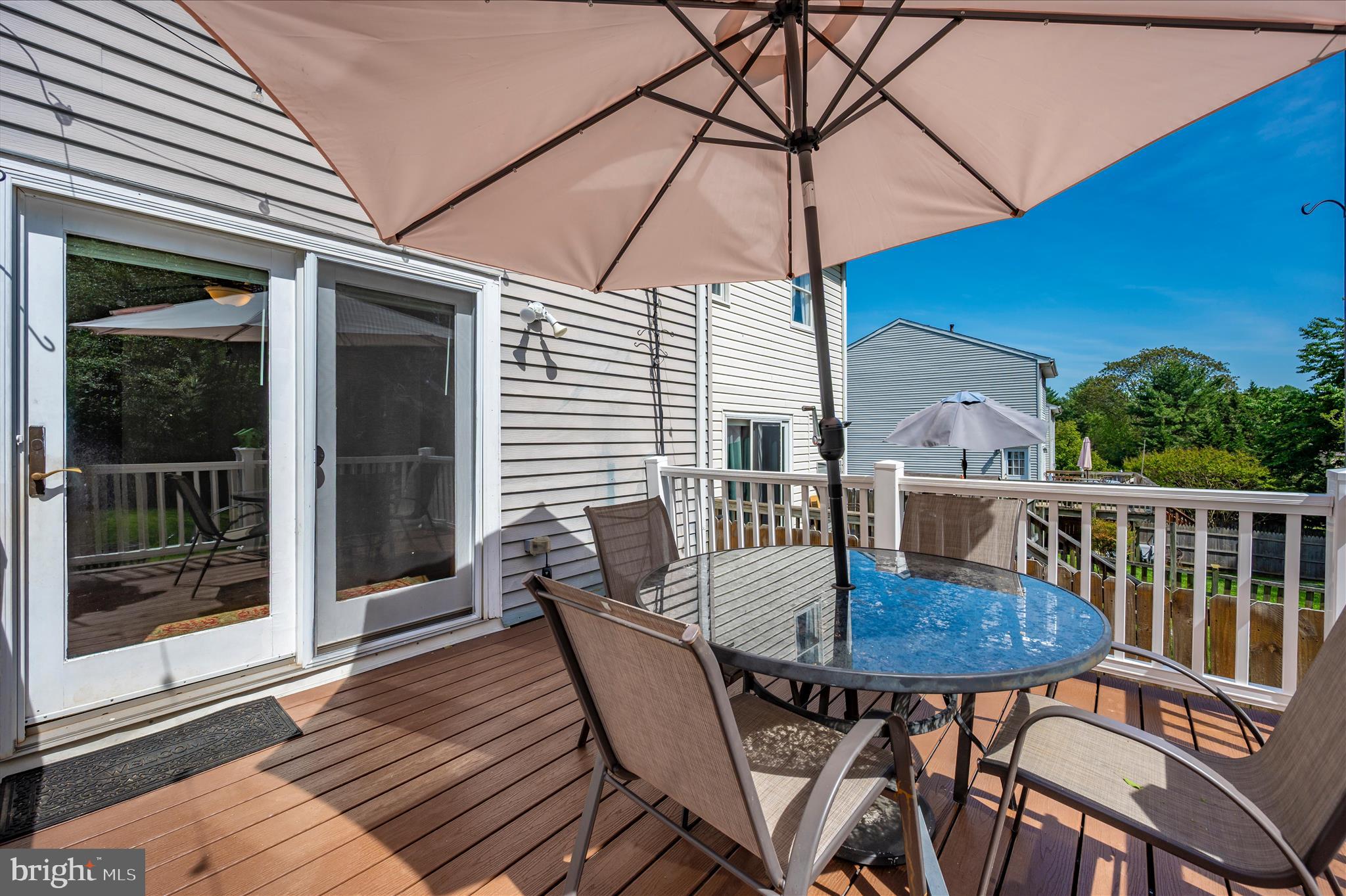 10120 Nightingale Street Gaithersburg, MD 20882 - Photo 46 of 56 a view of a balcony with a table and chairs under an umbrella