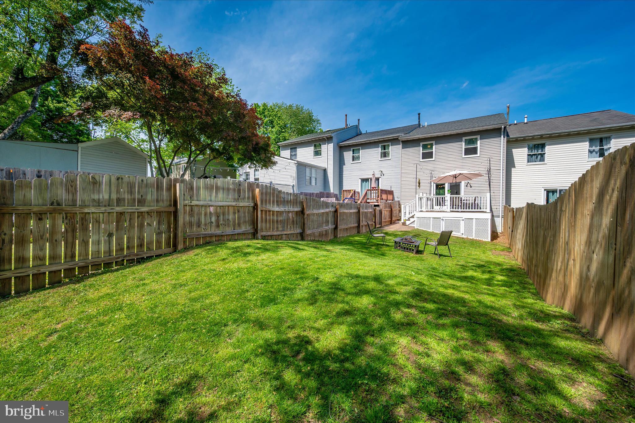 10120 Nightingale Street Gaithersburg, MD 20882 - Photo 52 of 56 a view of a backyard with table and chairs and wooden fence