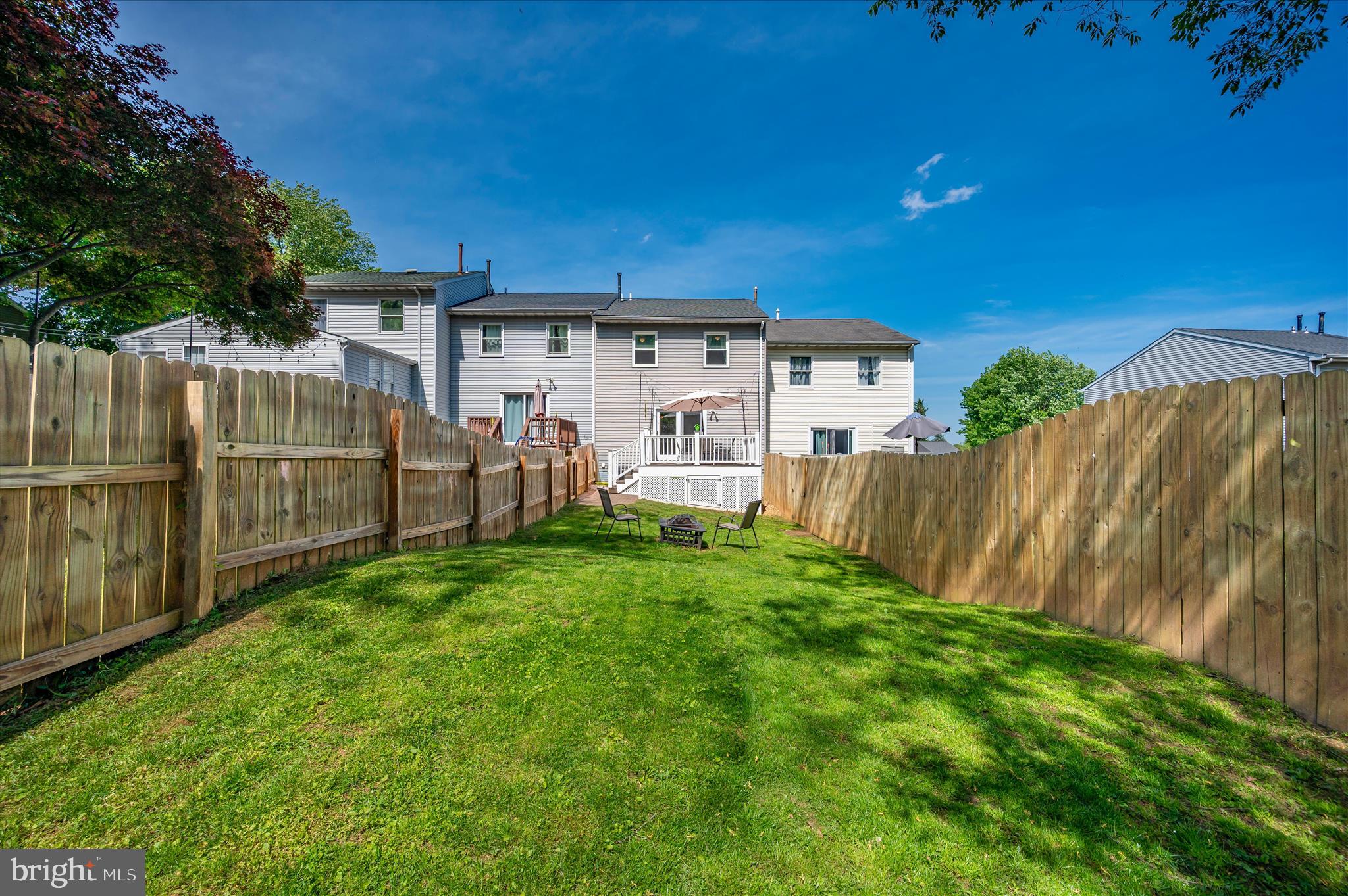 10120 Nightingale Street Gaithersburg, MD 20882 - Photo 53 of 56 a view of a backyard with wooden fence and a large tree