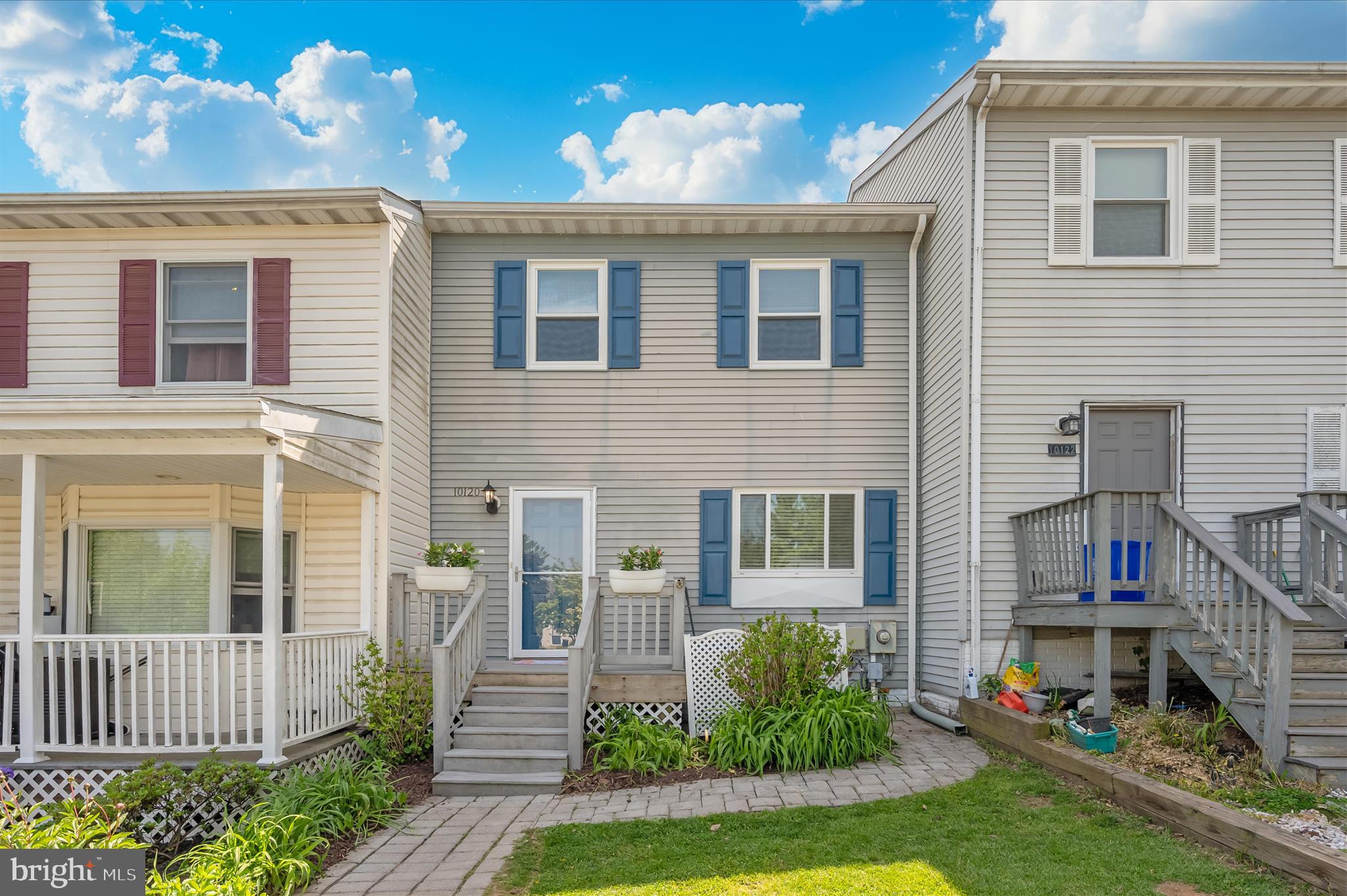 10120 Nightingale Street Gaithersburg, MD 20882 - Photo 54 of 56 a front view of a house with a yard and potted plants