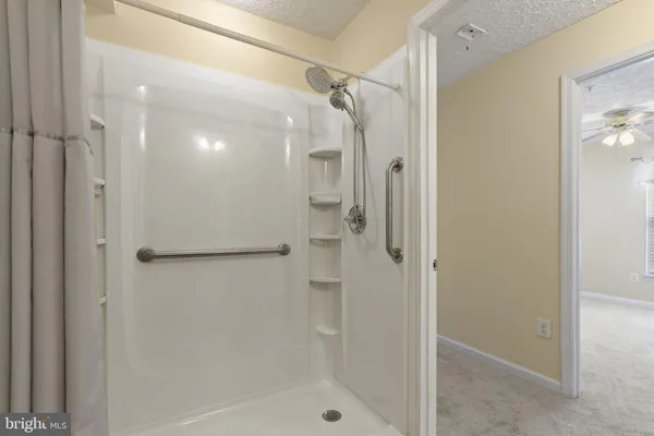 a bathroom with a glass shower door