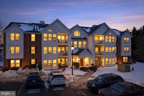 a front view of a residential apartment building with a yard