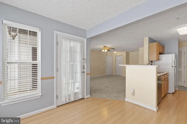 a view of a kitchen with a sink dishwasher and a refrigerator