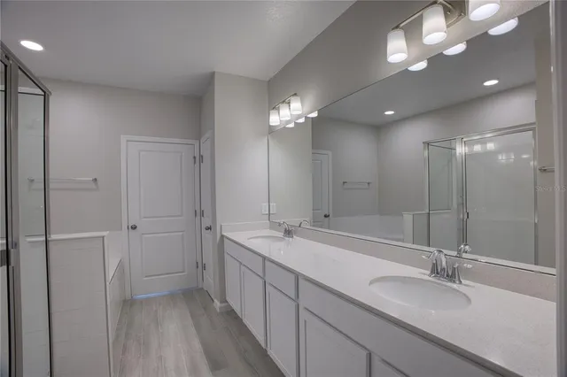 a bathroom with a double vanity sink and a mirror