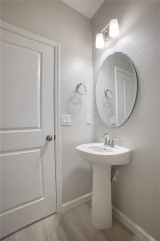a bathroom with a sink a mirror and vanity