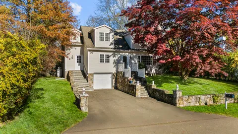 a dining hall with stainless steel appliances granite countertop a stove top oven a dining table and chairs with wooden floor