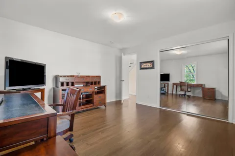 a view of a livingroom with workspace and a window
