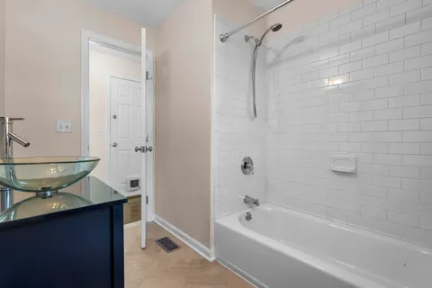 a spacious bathroom with a granite countertop toilet a sink and a bathtub