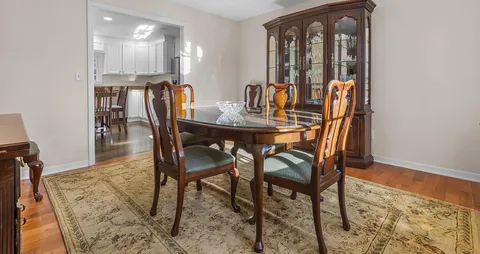 a view of a dining room with furniture window and wooden floor