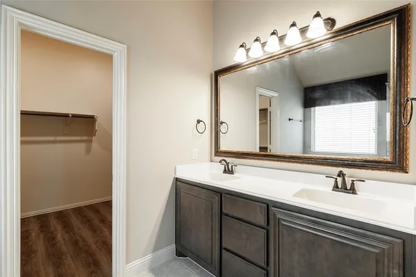 a bathroom with a sink vanity and mirror