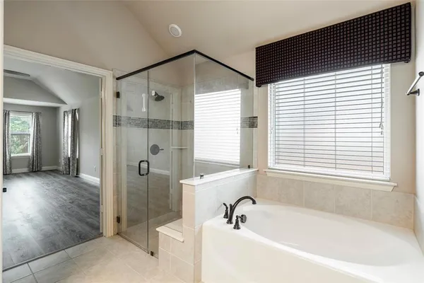 a bathroom with a bathtub and a shower